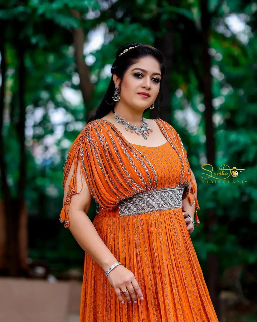 Meghana Raj Wearing Beautiful Earring Jewellery Orange Gown